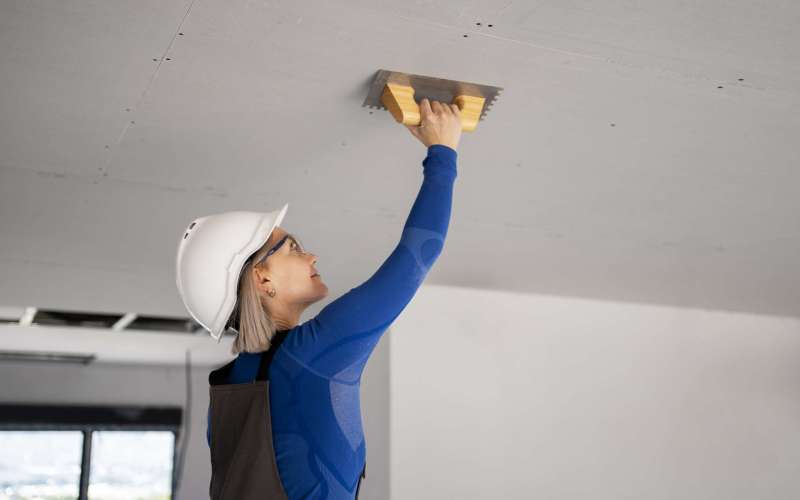 medium-shot-smiley-woman-fixing-roof
